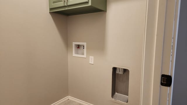 clothes washing area with washer hookup and cabinets