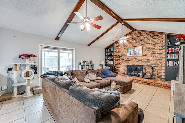 3213 Sunset Dr, San Angelo, TX 76904 - living room featuring a textured ceiling, a ceiling fan, light tile patterned flooring, a fireplace, and brick wall