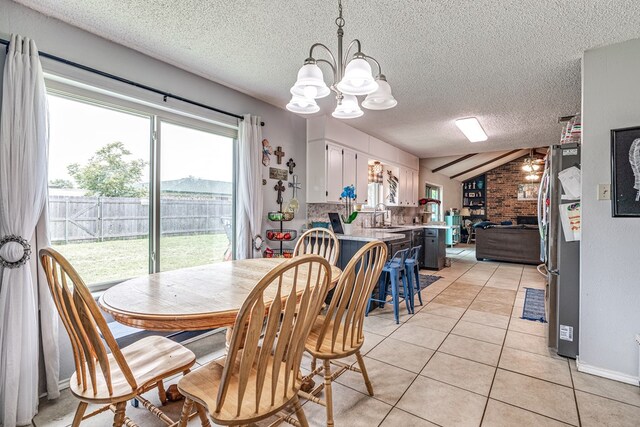 3213 Sunset Dr, San Angelo, TX 76904 - dining area with a textured ceiling, a chandelier, light tile patterned floors, a ceiling fan, and vaulted ceiling