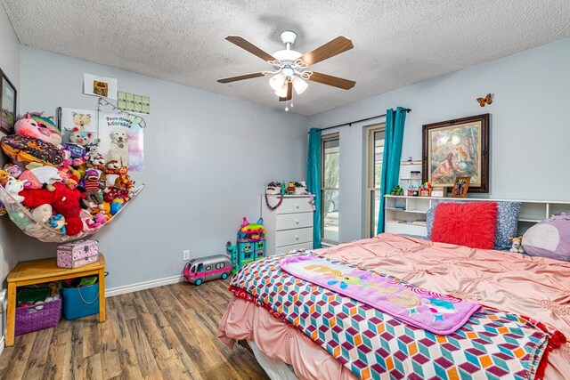 3213 Sunset Dr, San Angelo, TX 76904 - bedroom with wood finished floors, a textured ceiling, baseboards, access to outside, and a ceiling fan