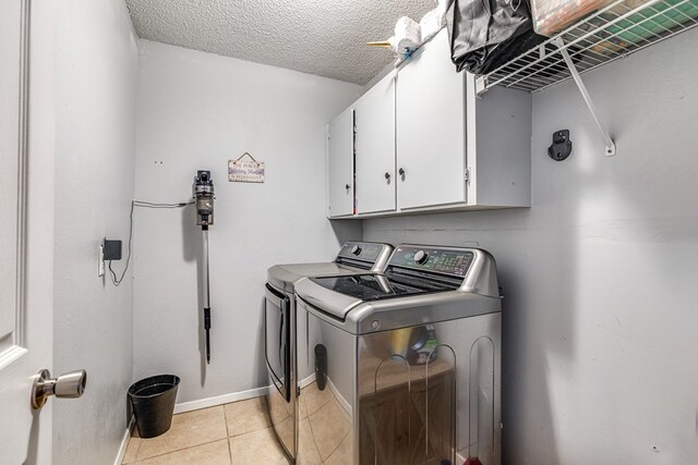 3213 Sunset Dr, San Angelo, TX 76904 - washroom with cabinet space, independent washer and dryer, light tile patterned flooring, a textured ceiling, and baseboards