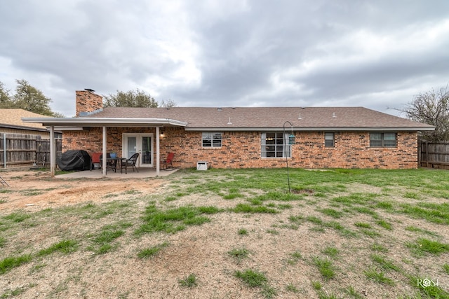 3213 Sunset Dr, San Angelo, TX 76904 - rear view of property with brick siding, a patio, a chimney, and french doors