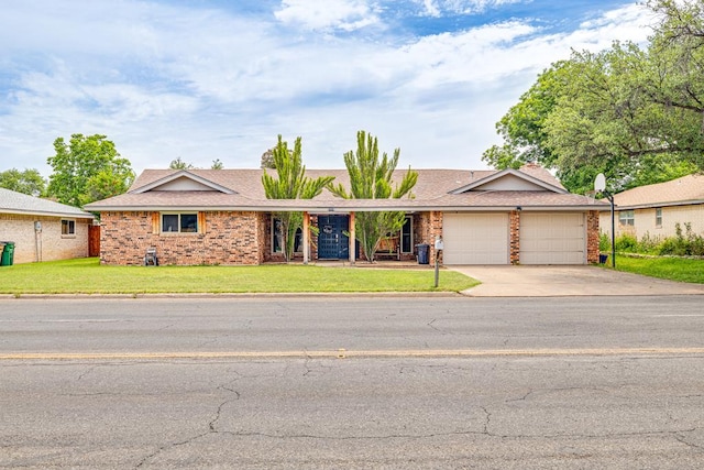 3213 Sunset Dr, San Angelo, TX 76904 - single story home featuring an attached garage, concrete driveway, brick siding, and a front yard