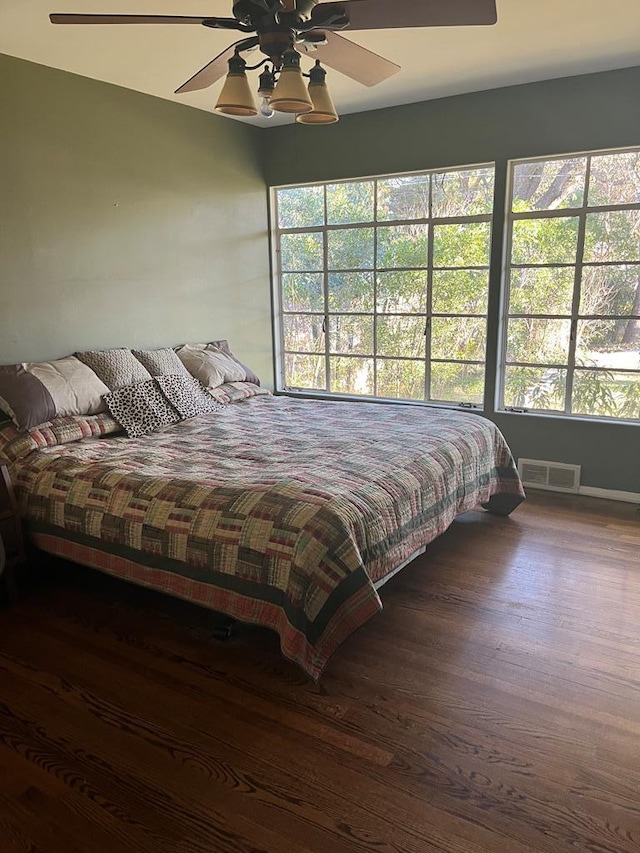 bedroom with dark wood-type flooring and ceiling fan