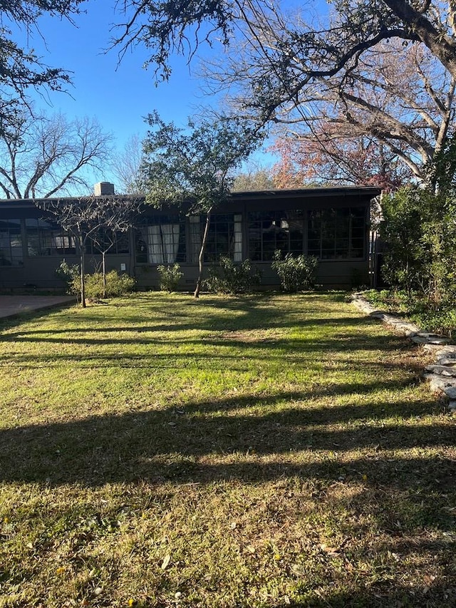 view of yard with a sunroom