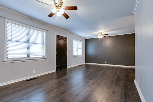 entrance foyer with ornamental molding, plenty of natural light, and dark wood-type flooring