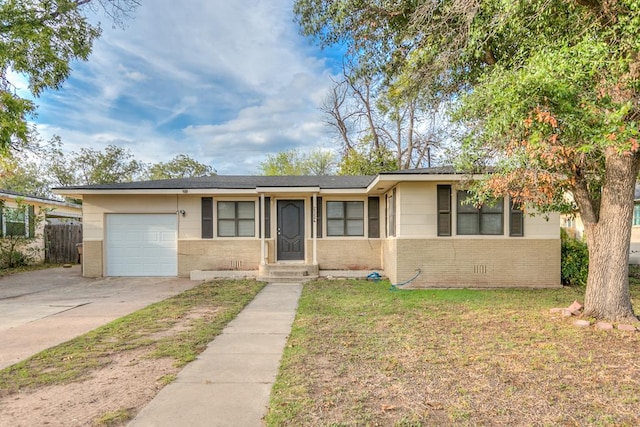 single story home featuring a garage and a front lawn