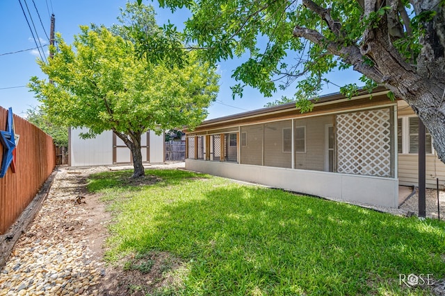 25 Dellwood Dr, San Angelo, TX 76903 - rear view of property with a fenced backyard, a sunroom, and a shed