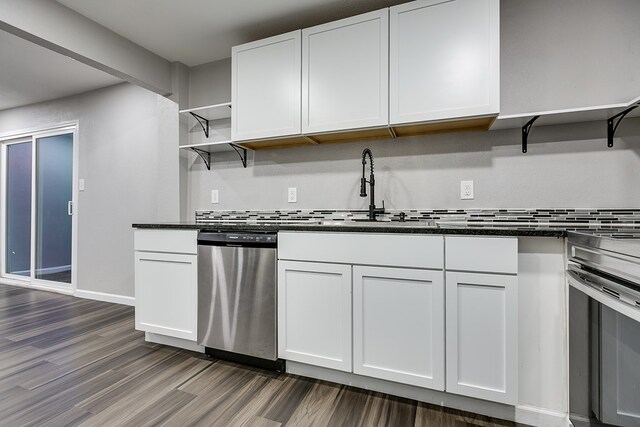 6622 Knickerbocker Rd, San Angelo, TX 76904 - kitchen featuring stainless steel appliances, open shelves, dark wood-style flooring, and decorative backsplash