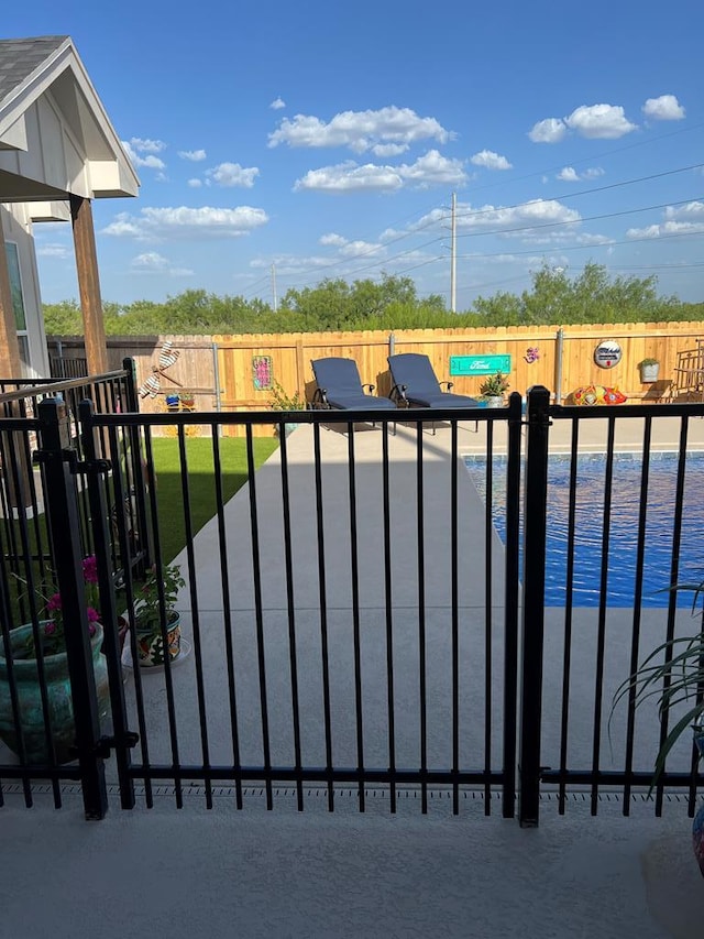 view of gate featuring a fenced backyard