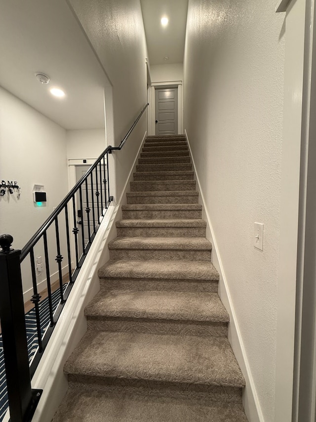 staircase featuring baseboards