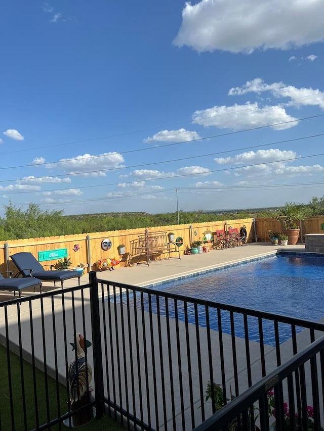 view of swimming pool with a patio, a fenced backyard, and a fenced in pool