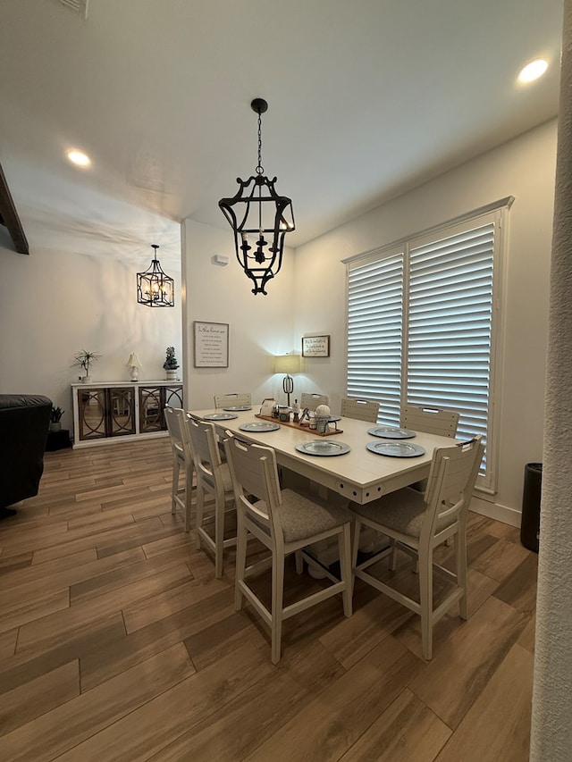 dining room featuring recessed lighting, a notable chandelier, and wood finished floors