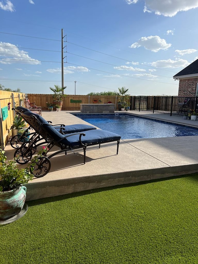 view of swimming pool featuring a patio area, a fenced backyard, and a fenced in pool