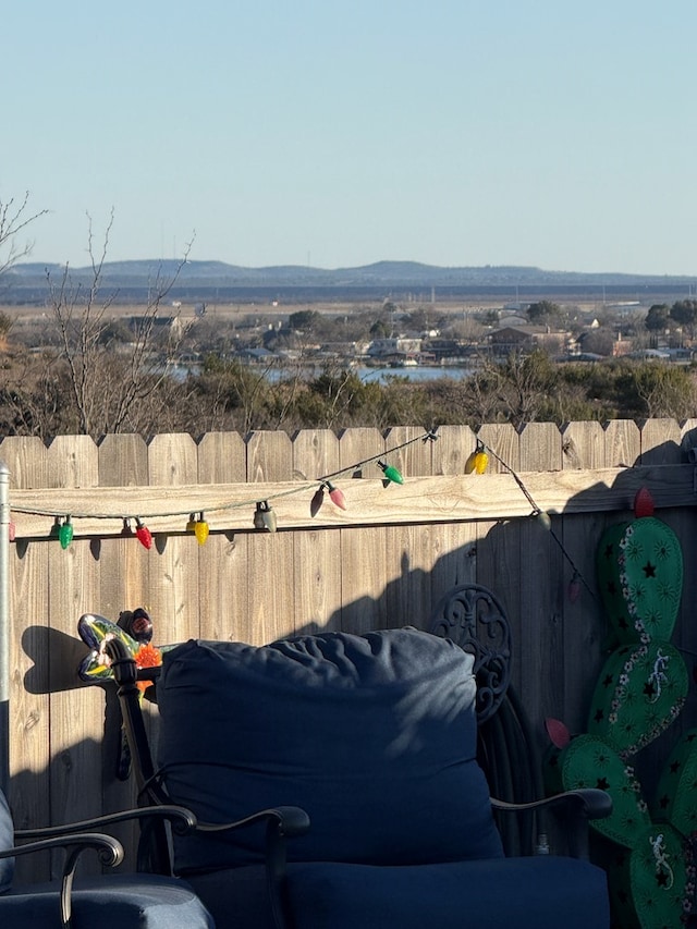 view of yard with a mountain view and fence