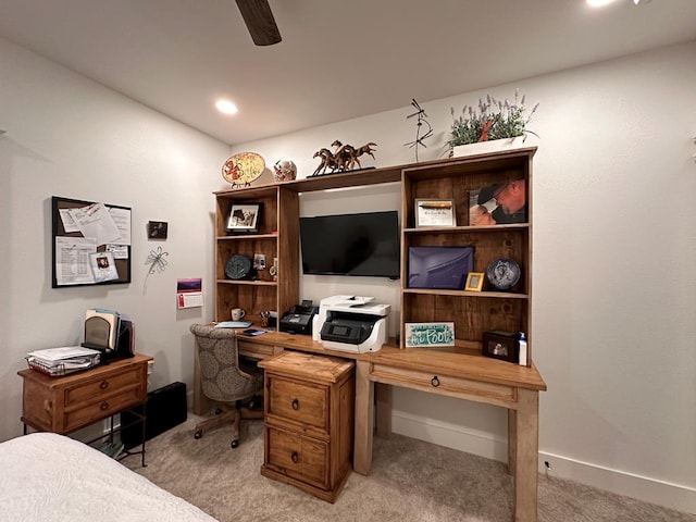 office space featuring a ceiling fan, light carpet, and baseboards