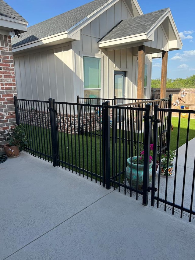 view of gate featuring a yard and fence