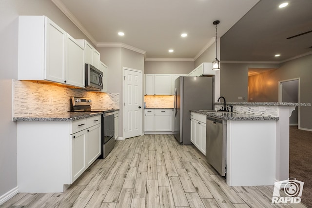 kitchen with white cabinetry, decorative backsplash, and appliances with stainless steel finishes