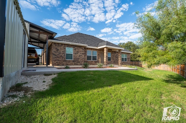 back of house with a lawn