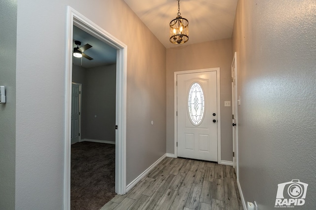 entryway with a chandelier and light wood-type flooring