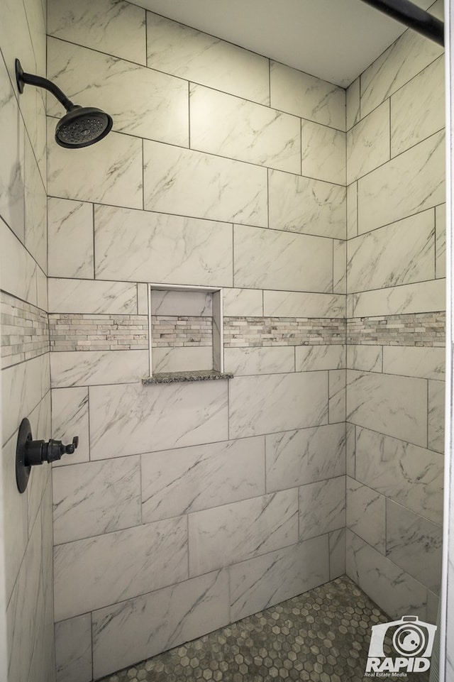 bathroom with a tile shower