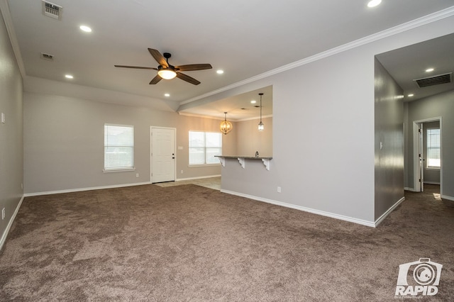 unfurnished living room featuring ceiling fan with notable chandelier, ornamental molding, and dark colored carpet