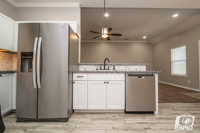 kitchen with sink, light stone counters, stainless steel appliances, light hardwood / wood-style floors, and white cabinets