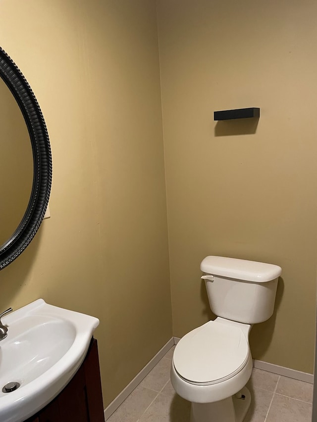 bathroom featuring tile patterned floors, baseboards, vanity, and toilet