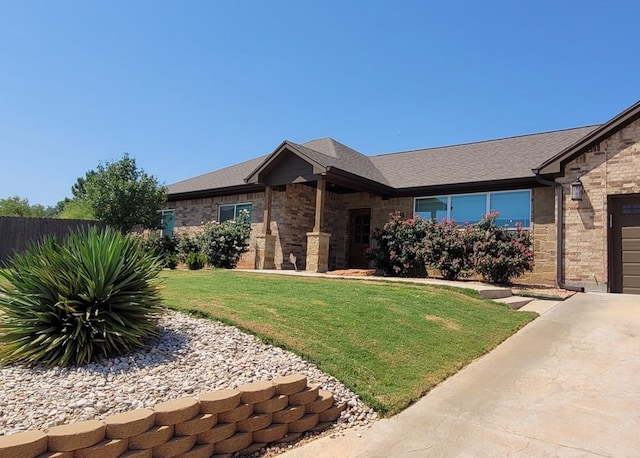 view of front of property with a garage and a front yard