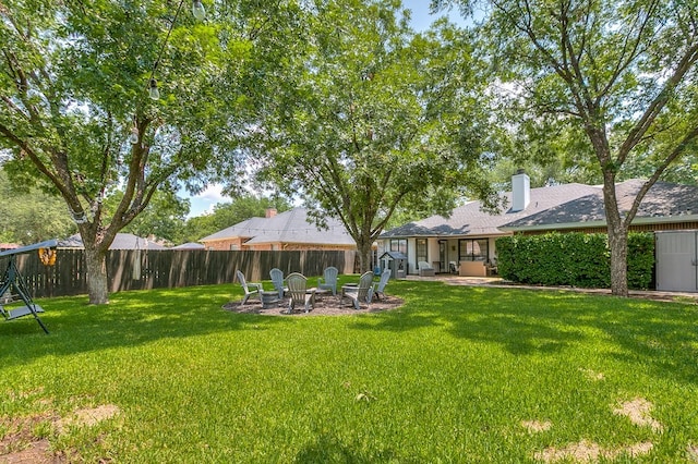 6033 Winners Cir, San Angelo, TX 76904 - view of yard featuring a fire pit and a patio area