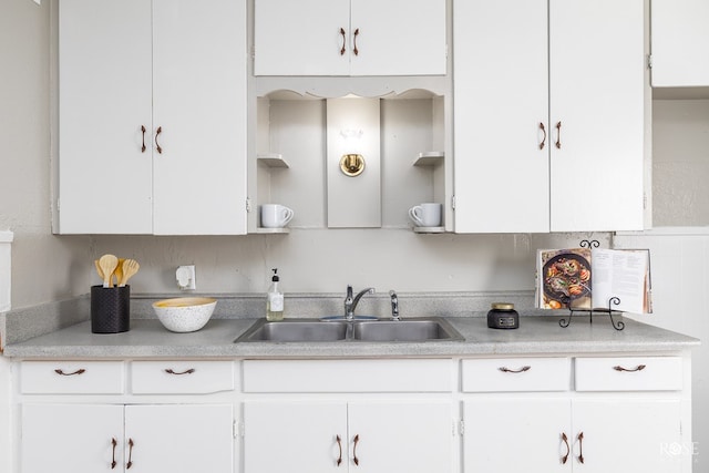 kitchen featuring white cabinetry, sink, and decorative backsplash