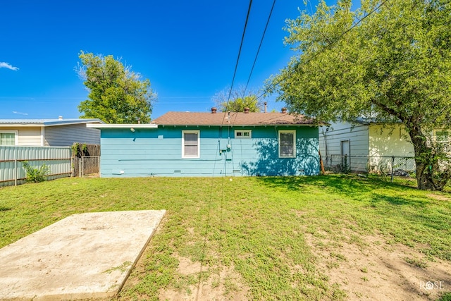 back of property featuring a yard