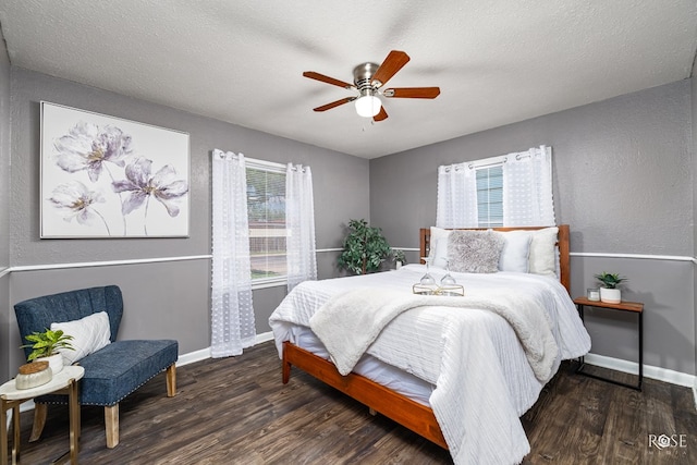 bedroom with dark hardwood / wood-style flooring, a textured ceiling, and ceiling fan