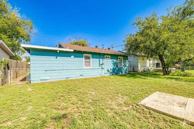 back of house with a yard