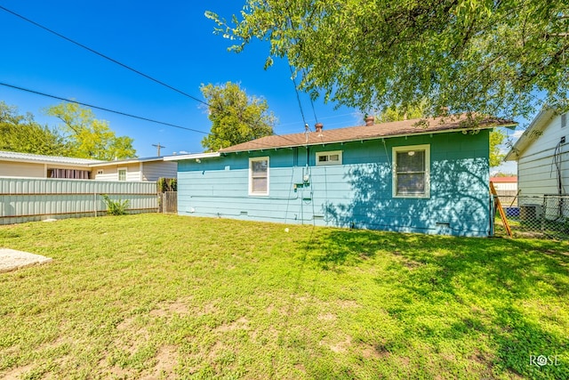 rear view of property with a yard