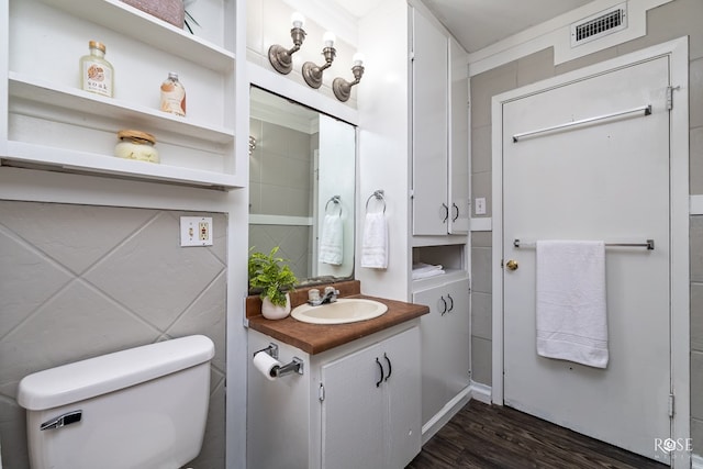 bathroom with vanity, hardwood / wood-style floors, and toilet