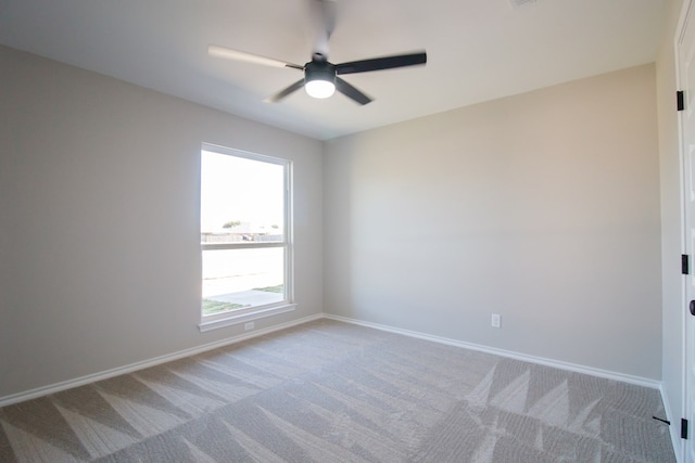 unfurnished room with ceiling fan and light carpet