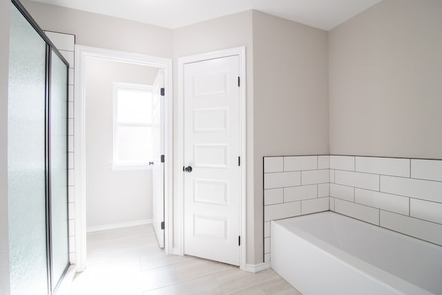 bathroom featuring separate shower and tub