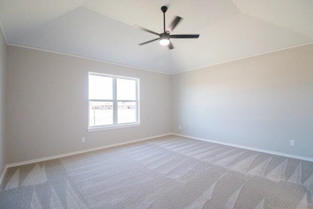 carpeted empty room with lofted ceiling, ornamental molding, and ceiling fan