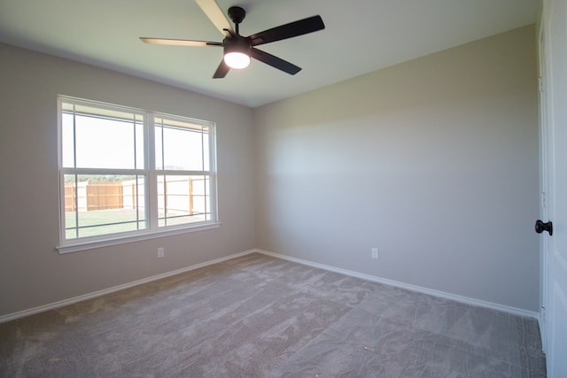 empty room featuring light colored carpet and ceiling fan