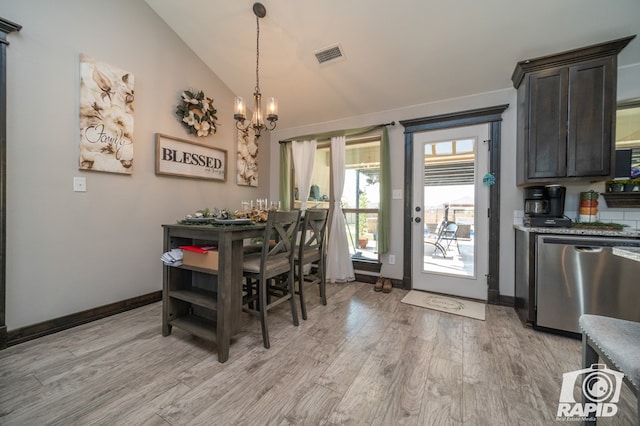 dining room featuring visible vents, baseboards, vaulted ceiling, light wood-style flooring, and an inviting chandelier