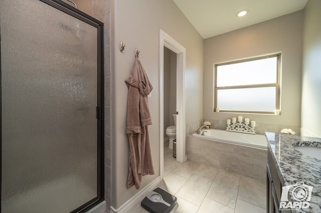 full bathroom featuring tile patterned flooring, a shower stall, toilet, a bath, and vanity