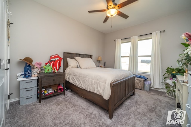 bedroom featuring lofted ceiling, a ceiling fan, baseboards, and light carpet