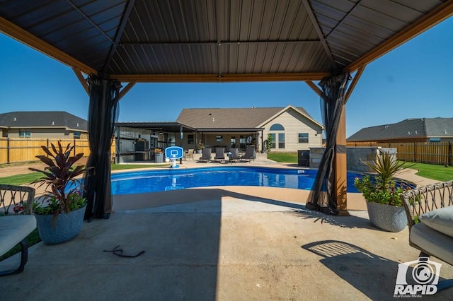 view of swimming pool featuring a gazebo, a fenced in pool, a fenced backyard, and a patio area