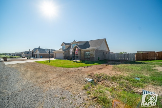 view of front of house with fence, a chimney, a garage, stone siding, and driveway