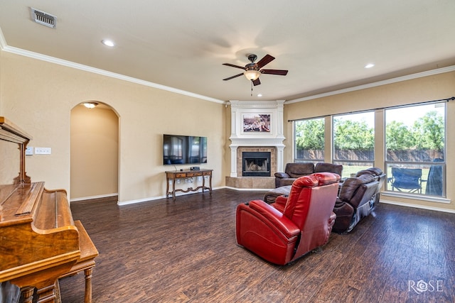 3926 Caroline Ln, San Angelo, TX 76904 - living room featuring a ceiling fan, wood finished floors, a fireplace, arched walkways, and crown molding