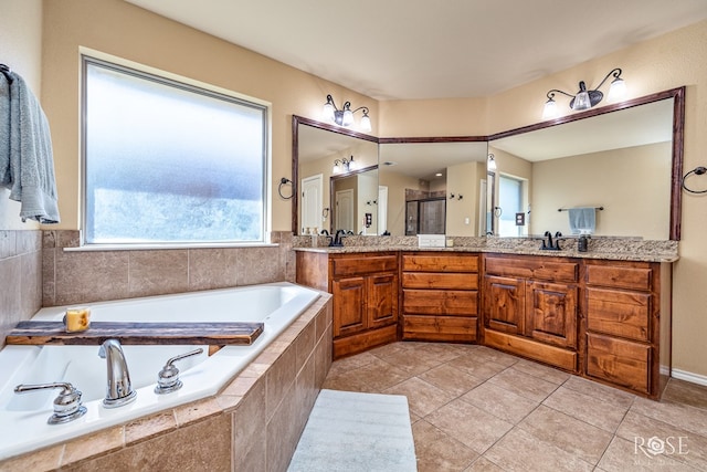 3926 Caroline Ln, San Angelo, TX 76904 - bathroom featuring double vanity, a bath, a shower stall, and tile patterned floors