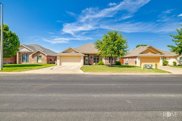 3926 Caroline Ln, San Angelo, TX 76904 - view of front of house with driveway, a garage, a front lawn, and brick siding