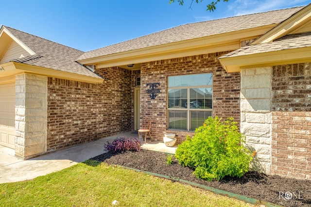 3926 Caroline Ln, San Angelo, TX 76904 - entrance to property featuring brick siding, a shingled roof, and an attached garage