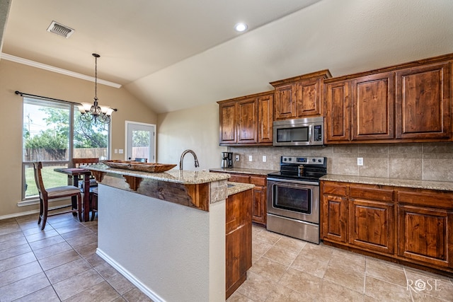 3926 Caroline Ln, San Angelo, TX 76904 - kitchen featuring appliances with stainless steel finishes, lofted ceiling, decorative backsplash, a chandelier, and light stone counters